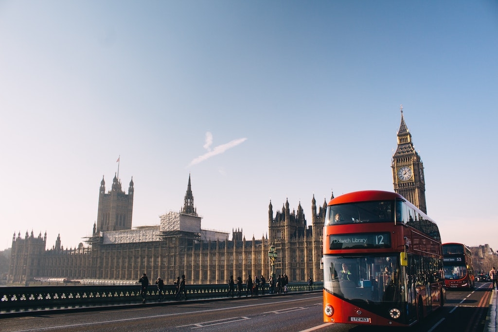 Double-decker bus with the Houses of Parliament in London in the background